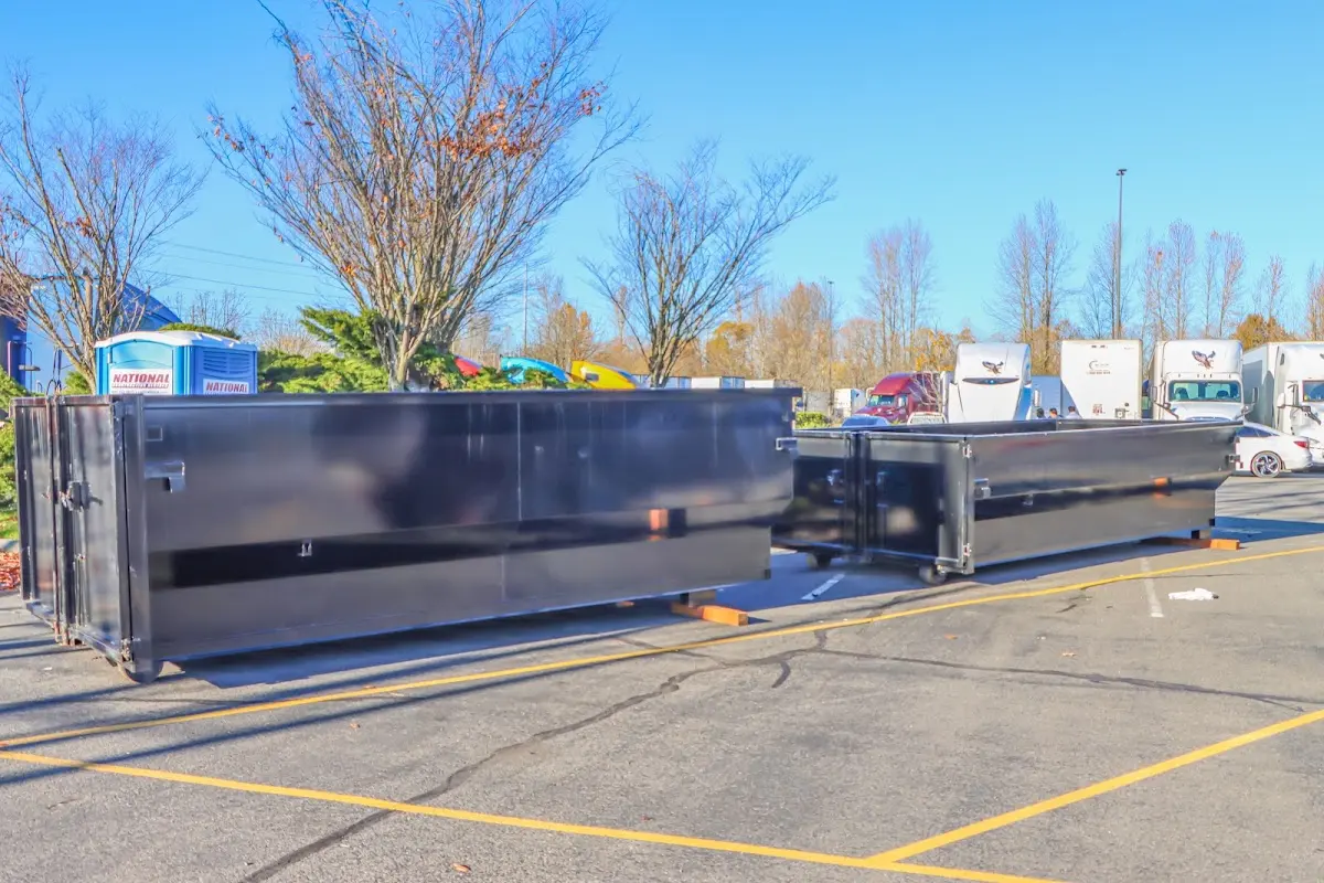 Professional dumpster rental service with roll-off container on residential driveway in Upper Makefield